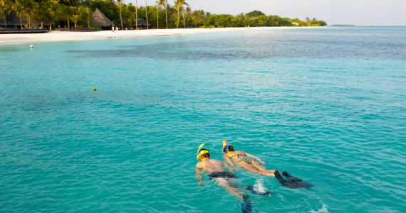 two people snorkeling in a tropical location
