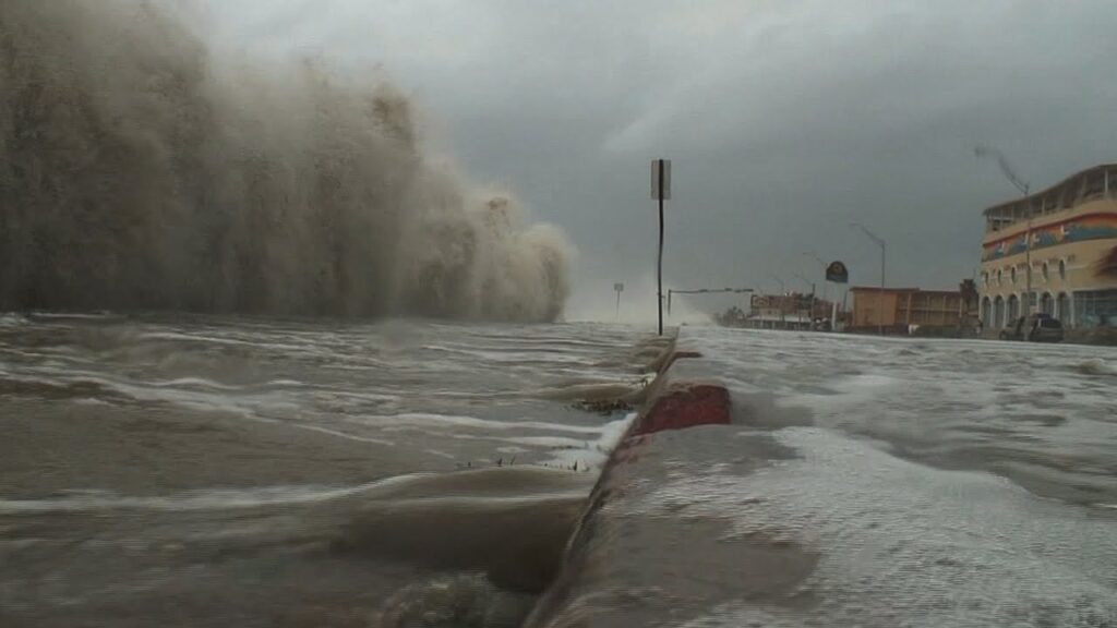 a hurricane storm surge coming over a sea wall