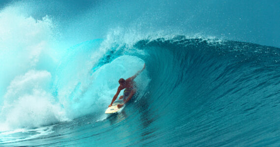 a person surfing a huge wave