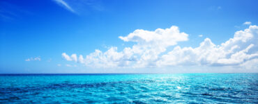 a view of the open ocean on a sunny day