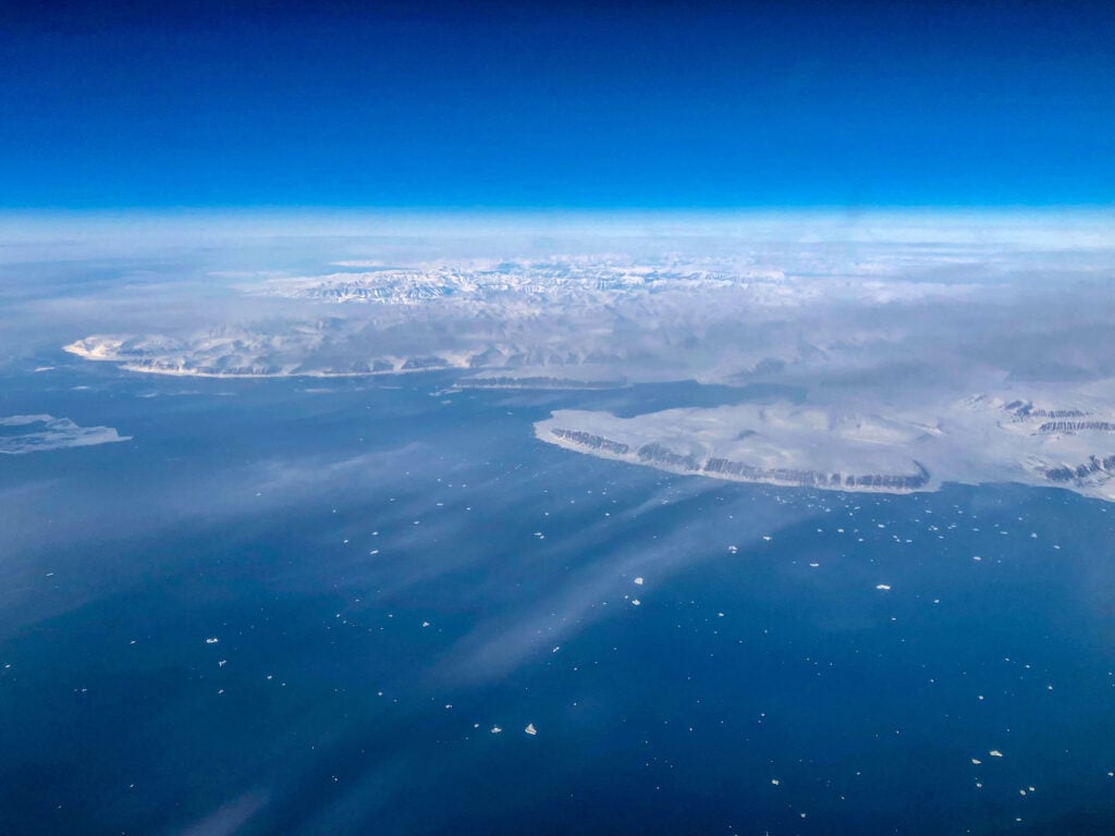 a view of greenland from the window of an airplane