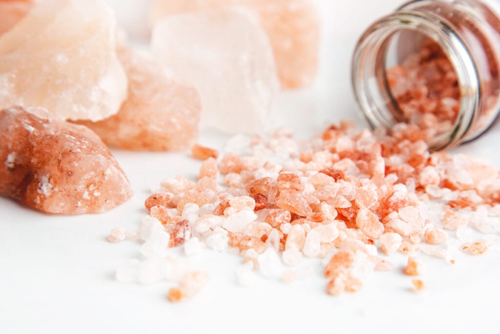 a jar of himalayan pink salt spilling out