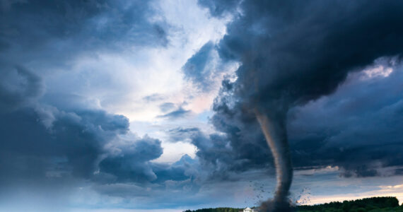 tornado ripping through the field of a farm