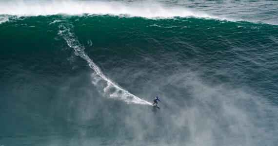 a surfer riding a gigantic wave