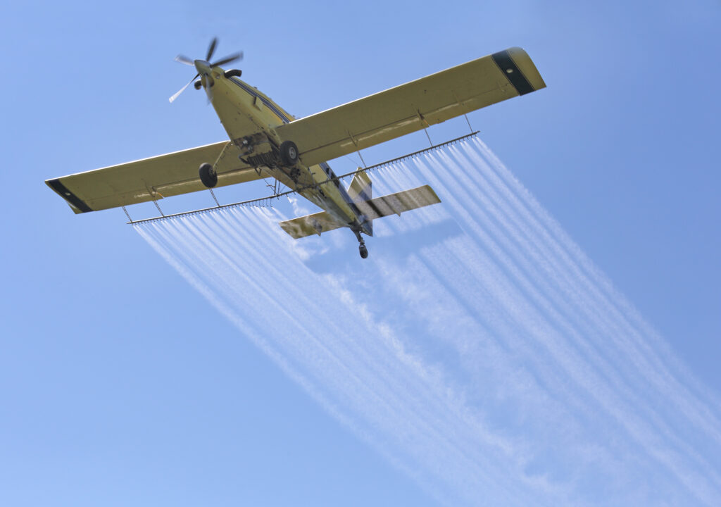 an airplane spraying compounds in the air