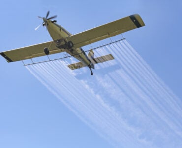 an airplane spraying compounds in the air