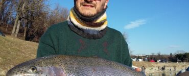 a man holding an enormous rainbow trout