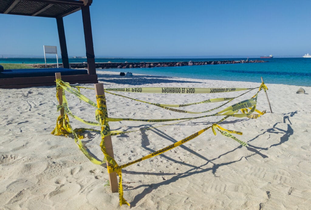 a sea turtle nest cordoned off at a beach