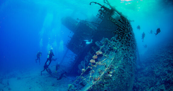 divers exploring a shipwreck