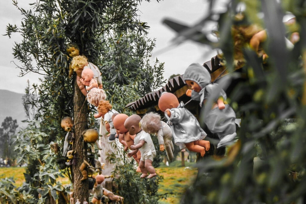 dolls hanging on a rope in a tree in mexico