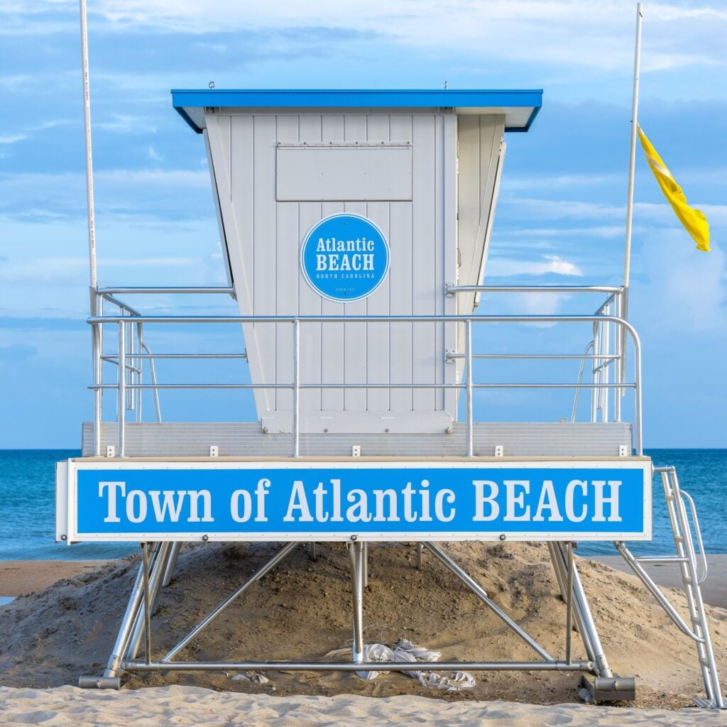 Atlantic Beach NC - May 12 2022: Lifeguard stand on the beach that says Town of Atlantic Beach during golden hour