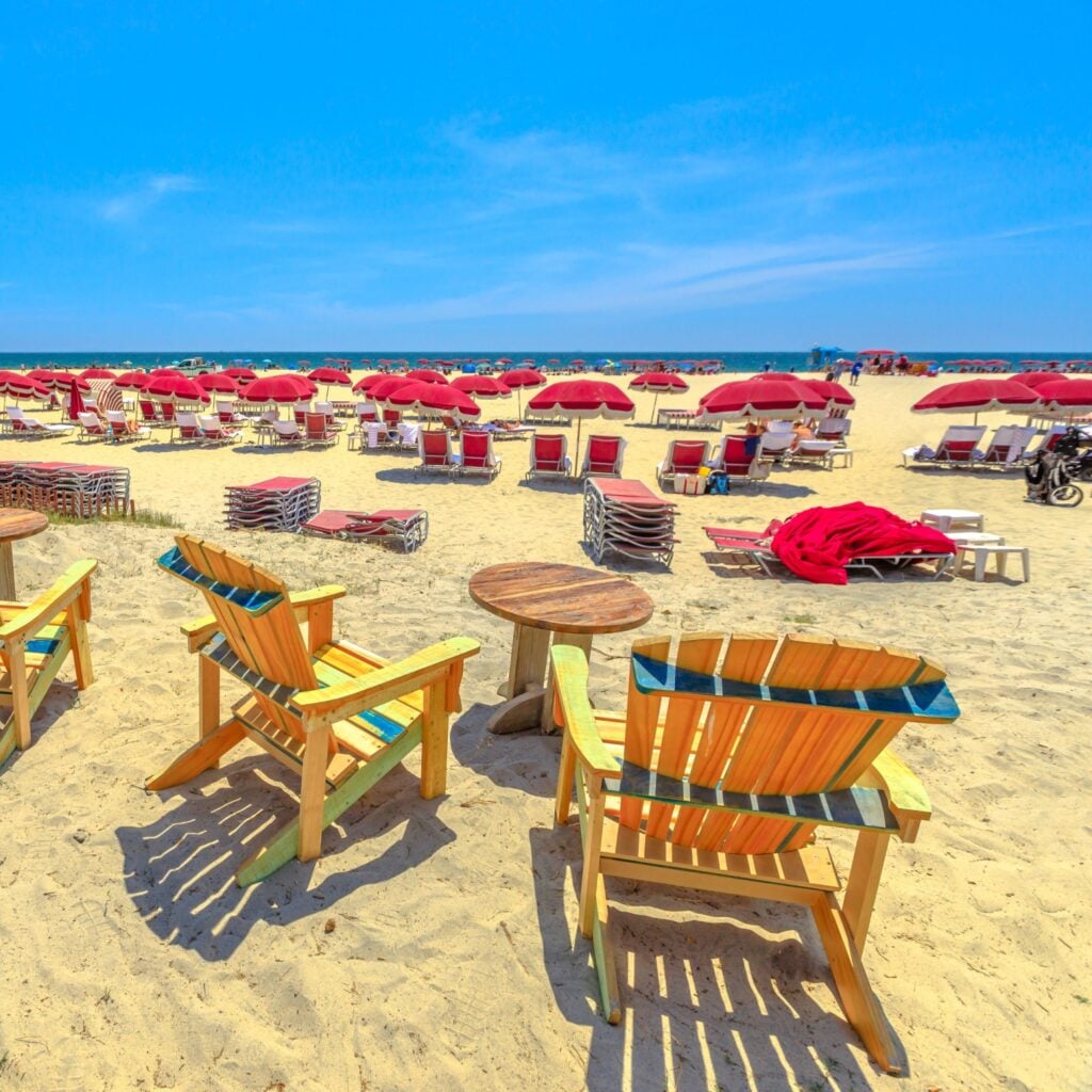 Sea chairs in Coronado Beach along Ocean Boulevard on Pacific Ocean, Coronado Island, San Diego. Summer season in West Coast, USA. Blue sky with copy space. Summer holidays in California.