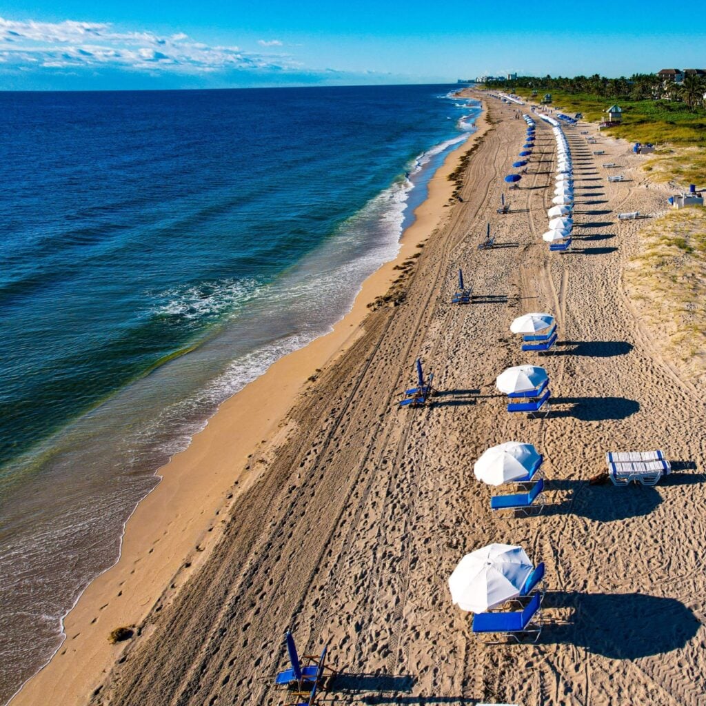 Delray Beach features a wide, clean shoreline with warm Atlantic waves, perfect for sunbathing and swimming, just steps from lively shops and cafes nearby.