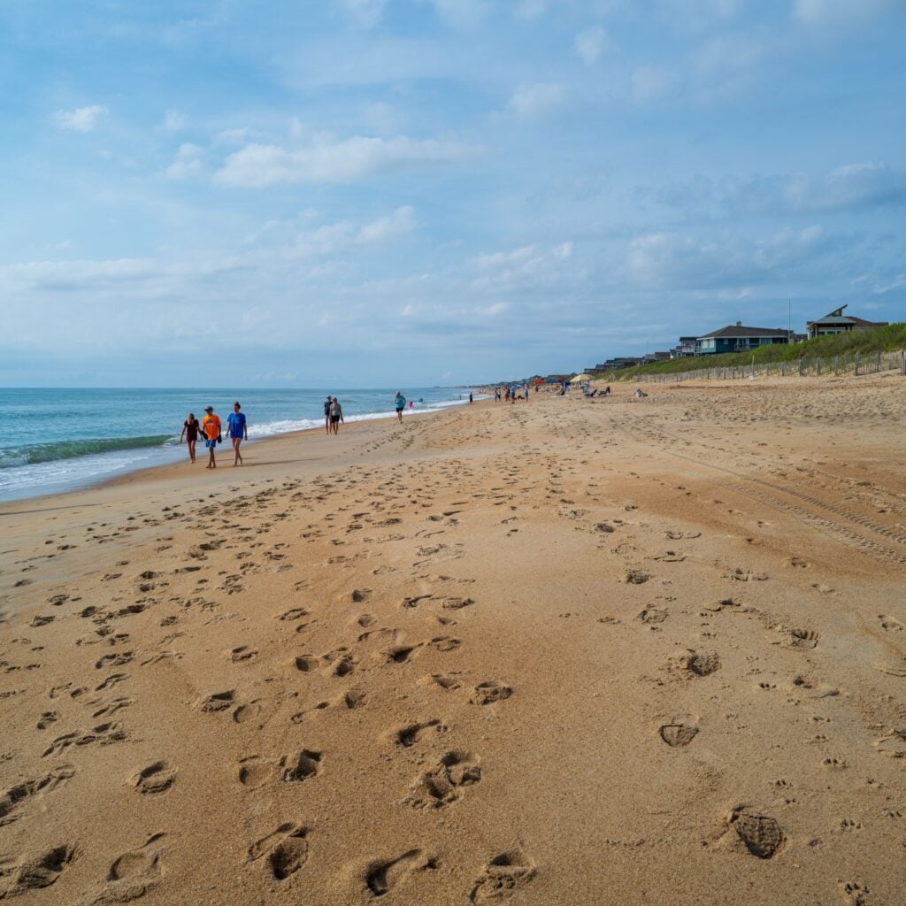 Duck, North Carolina, USA -- June 9, 2020. Visitors walk the beautiful morning beach in Duck, NC.