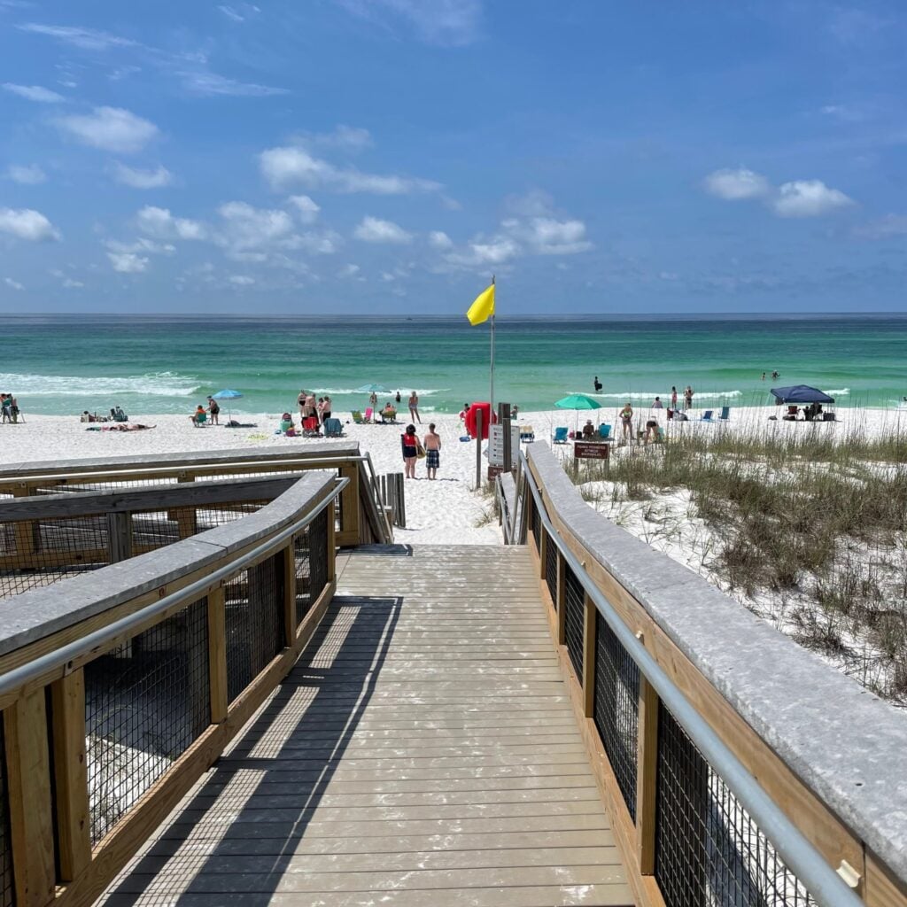 May 26, 2021 Henderson Beach State Park Destin, Florida USA. People crowd Florida’s Emerald Coast white sand beach on a warm spring day.