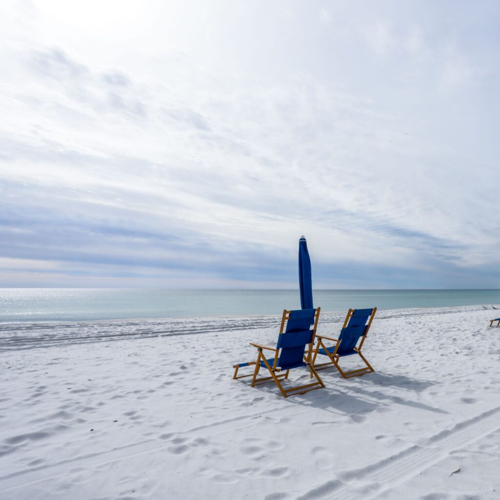 beach chairs and cabanas on navarre beach florida by ocean